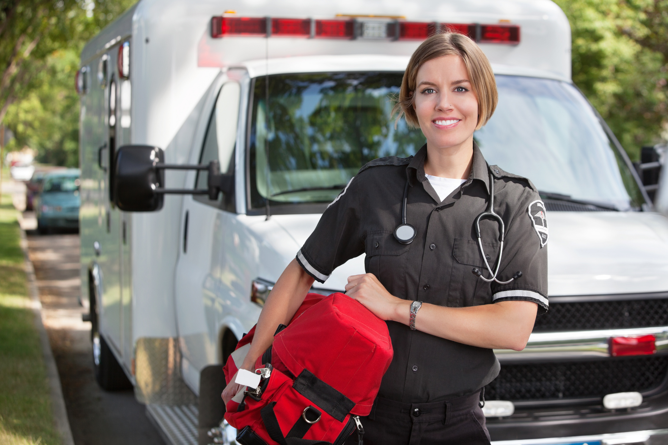 a paramedic is standing in front of an ambulance